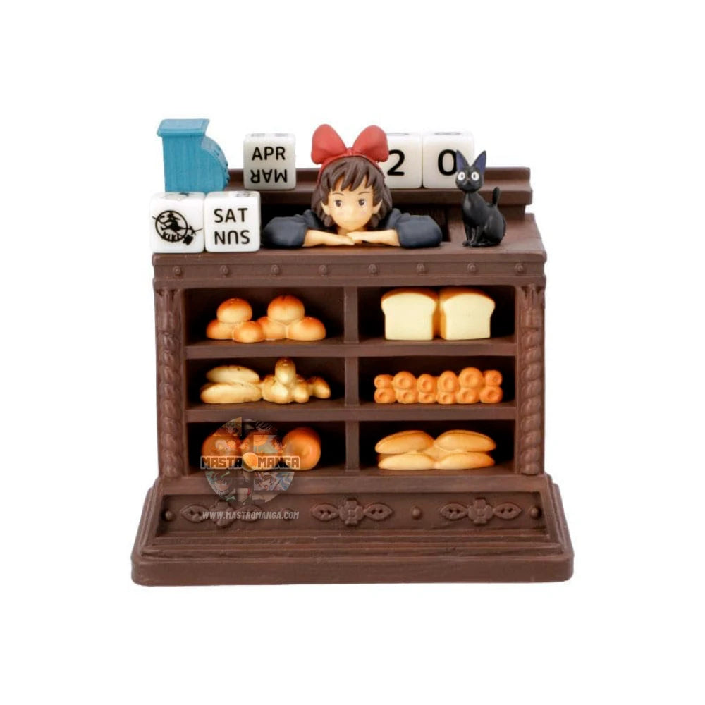 Calendario perpetuo ufficiale Studio Ghibli ispirato a Kiki - Consegne a domicilio, con Kiki in grembiule dietro il bancone del pane insieme al gatto Jiji e dadi per la data