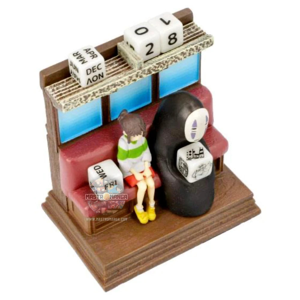 Calendario perpetuo ufficiale Studio Ghibli raffigurante Chihiro e Senzavolto seduti all'interno del treno Unabara di La Città Incantata, con dadi numerati per data e mese