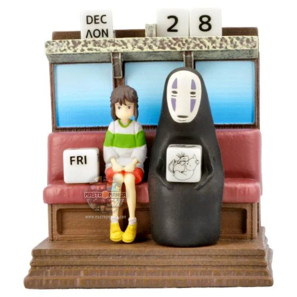 Calendario perpetuo ufficiale Studio Ghibli raffigurante Chihiro e Senzavolto seduti all'interno del treno Unabara di La Città Incantata, con dadi numerati per data e mese